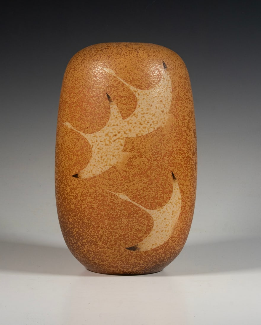 JAPANESE STYLE ART POTTERY STEM VASE: JAPANESE STYLE ART POTTERY STEM VASE Rouleau Form Vase in speckled tan glaze, featuring Cranes in flight, unsigned. Size: 10 3/4 x 6 x 6 in. (27.3 x 15.2 x 15.2 cm.)