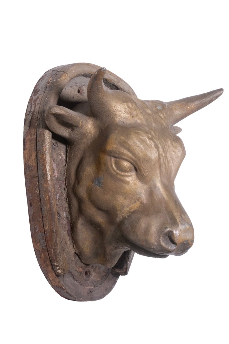 LATE 19TH C. SMALL METAL COW'S HEAD TRADE SIGN: LATE 19TH C. SMALL METAL COW'S HEAD TRADE SIGN Dimensional Exterior Molded Tin Sign in the original dull gold paint, set on the original wooden mount. Size: 8 x 10 x 13 in. (20.3 x 25.4 x 33 cm.)