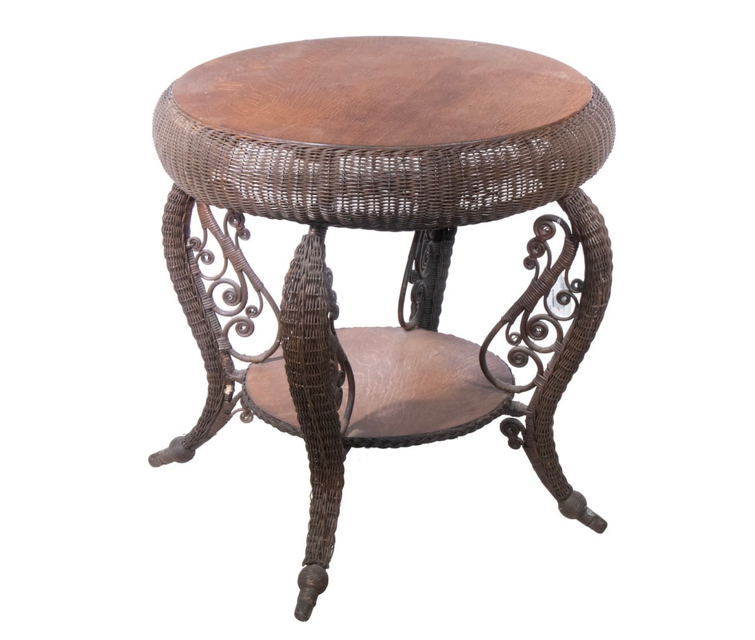 HEYWOOD-WAKEFIELD WICKER GAME TABLE, CA 1890: HEYWOOD-WAKEFIELD WICKER GAME TABLE, CA 1890 Natural Finish Round Table with quarter-sawn golden oak top, shawl rolled edge, sinuous tapered legs having spit curl brackets, lower shelf. Retains fragme