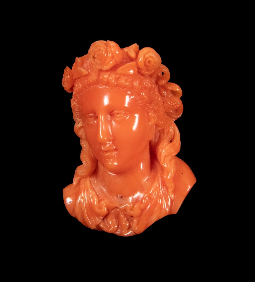 VICTORIAN 14K GOLD AND CARVED CORAL FEMALE BUST BROOCH: VICTORIAN 14K GOLD AND CARVED CORAL FEMALE BUST BROOCH A finely carved coral brooch depicting a classical female bust adorned with a floral wreath. The figure is rendered with softly modeled facial fe