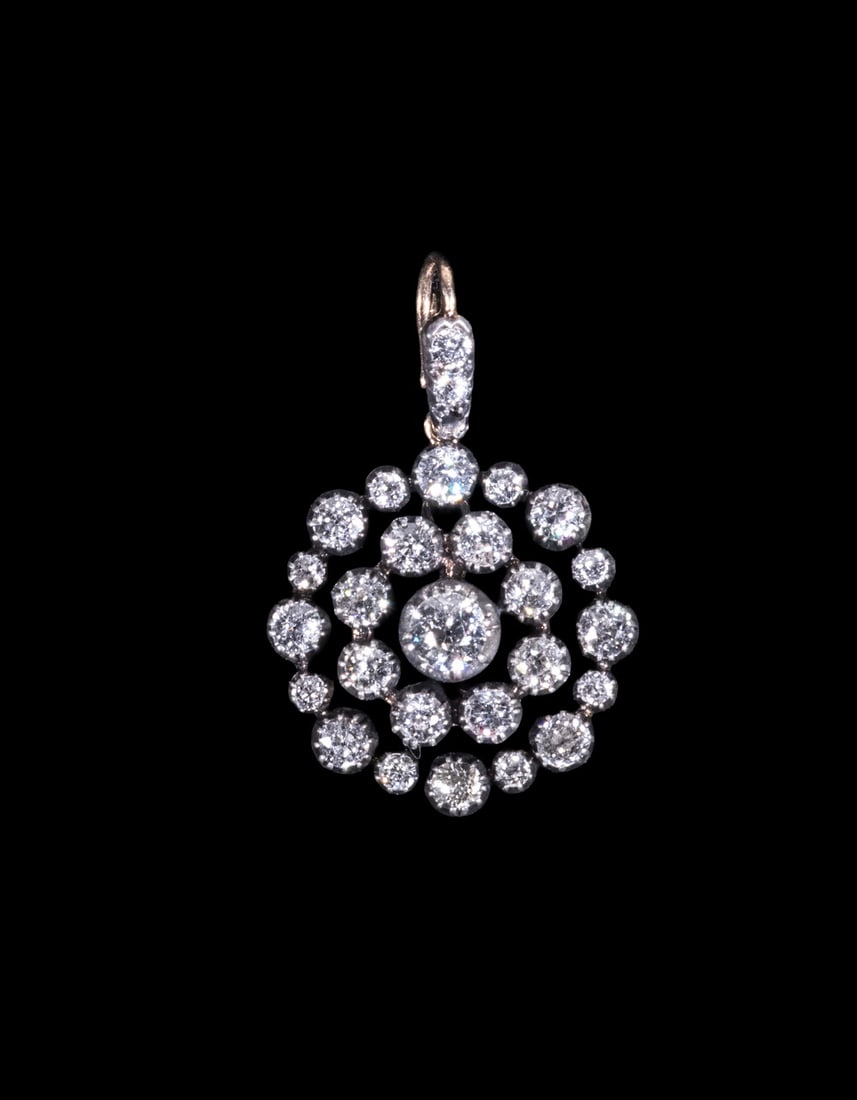 19TH CENTURY SILVER-TOPPED GOLD DIAMOND PENDANT: 19TH CENTURY SILVER-TOPPED GOLD DIAMOND PENDANT A circular pendant of openwork design, featuring a central old-cut diamond measuring approximately 5.11 mm, surrounded by concentric rows of smaller