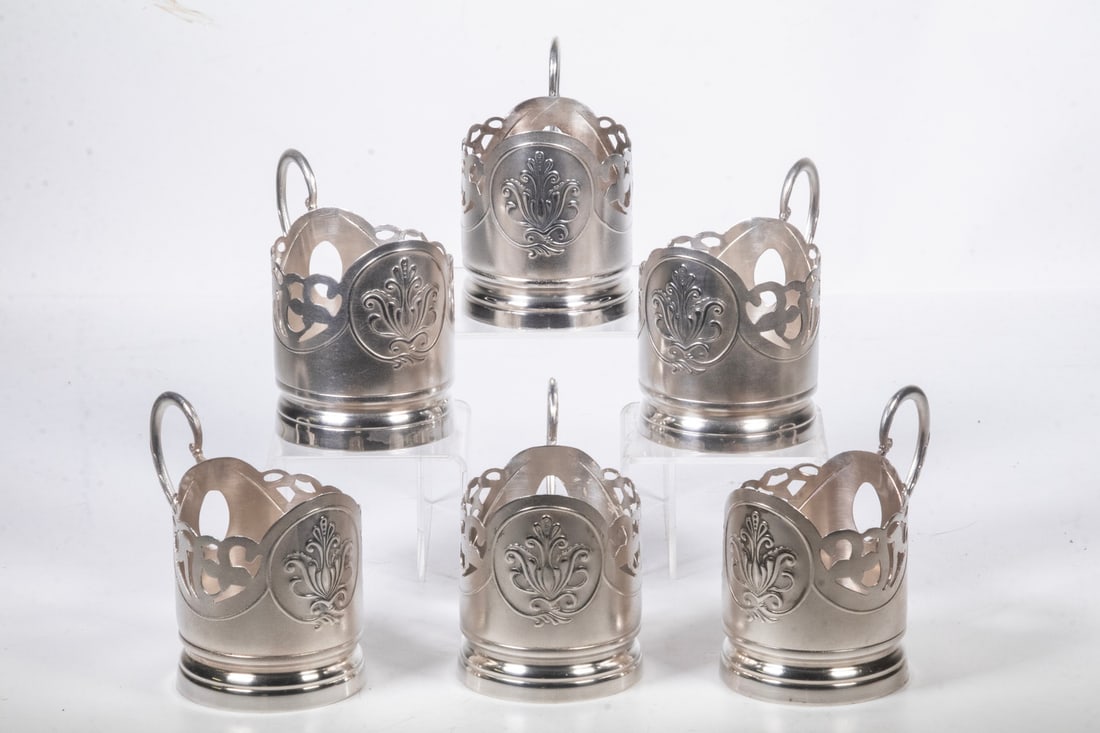 (6) RUSSIAN SOVIET ERA SILVER TEA GLASS HOLDERS: (6) RUSSIAN SOVIET ERA SILVER TEA GLASS HOLDERS Set of (6) 875-Silver Podstakanniks, with pierced sides and repousse decoration, decorated scroll handles, each with Kaliningrad assay inspection mark;