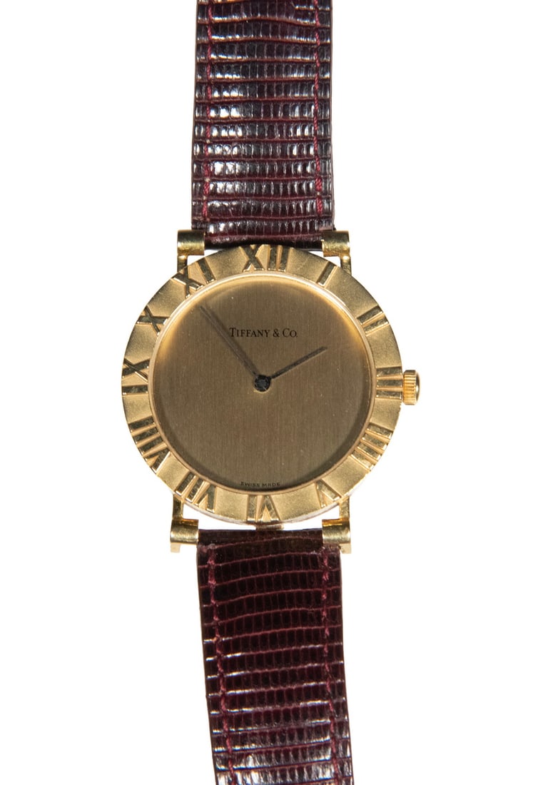 TIFFANY & CO. 18K GOLD ATLAS WRISTWATCH: TIFFANY & CO. 18K GOLD ATLAS WRISTWATCH 1980's Tiffany & Co. Atlas, 18K Yellow Gold Time Only Wristwatch. Round 30mm gold case with beautiful high relief Roman numerals on bezel. Simple and elegant