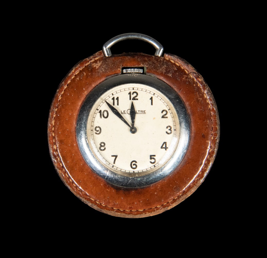LECOULTRE SWISS POCKET WATCH WITH LEATHER CASE: LECOULTRE SWISS POCKET WATCH WITH LEATHER CASE A LeCoultre Swiss pocket watch with a round silver-tone case, housed within a fitted brown leather holder. The dial with Arabic numerals and blued steel
