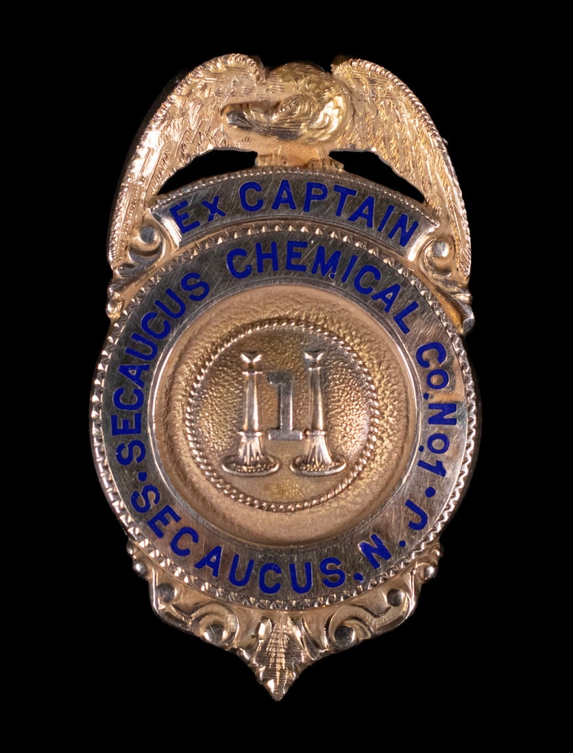 14K GOLD CORPORATE BADGE, SECAUCUS CHEMICAL CO., NEW JERSEY: 14K GOLD CORPORATE BADGE, SECAUCUS CHEMICAL CO., NEW JERSEY A solid gold corporate badge inscribed Ex-Captain Secaucus Chemical Co., N.J. , featuring an eagle crest and enamel lettering. Reverse