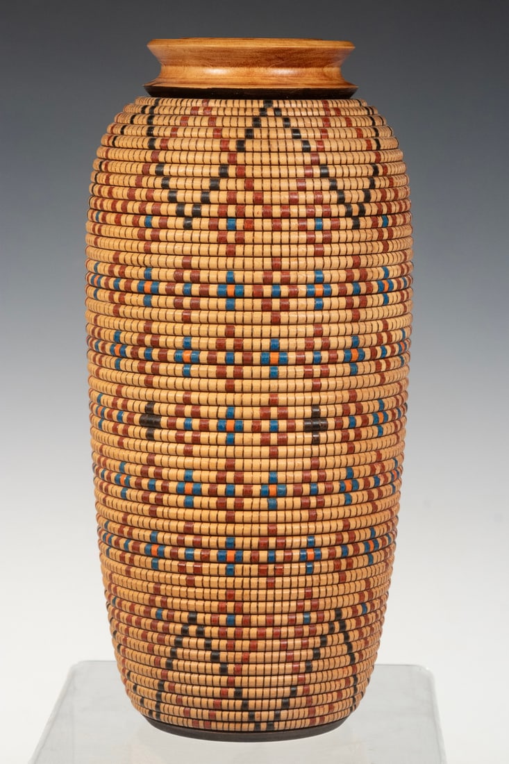 CARVED MAPLE VASE BY JACK LILLEY, MAINE: CARVED MAPLE VASE BY JACK LILLEY, MAINE Tall Ovid Turned Vase with faux basket weave carving, signed "J. Lilley, 623 Woodworks" (Smyrna Falls, Maine). Size: 10 1/2 x 4 1/2 in. (26.7 x 11.4 cm.)