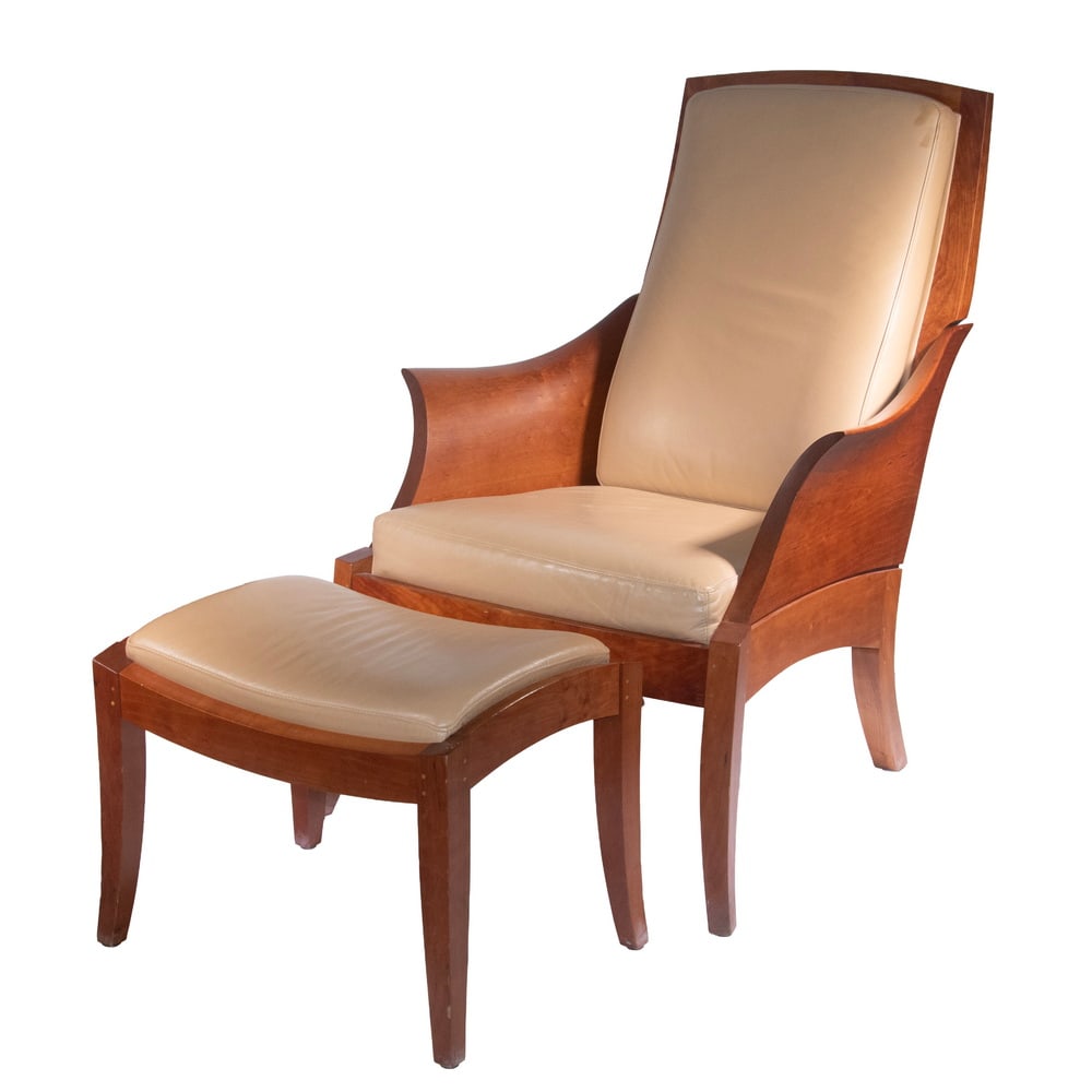 THOMAS MOSER "WING" ARMCHAIR & OTTOMAN: THOMAS MOSER "WING" ARMCHAIR & OTTOMAN (2)-Pieces of Maine Hand Crafted Furniture, in solid cherry; the armchair with curved back, sculpted flared arms, with tan (Riverside) leather upholstered back