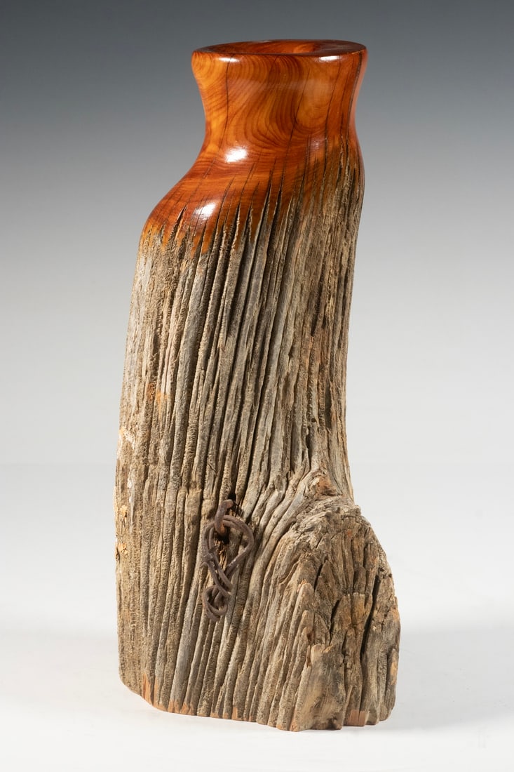 DOUG WAJDIC MONTANA FENCE POST VASE: DOUG WAJDIC MONTANA FENCE POST VASE Made from the top section of a weathered fence post, the top turned and hollowed out for use as a vase. Signed. Size: 13 x 4 x 6 in. (33 x 10.2 x 15.2 cm.)