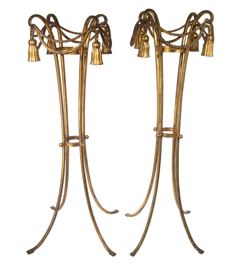 PAIR OF ITALIAN MID-CENTURY GILT IRON PLANT STANDS: PAIR OF ITALIAN MID-CENTURY GILT IRON PLANT STANDS Very Hollywood, consisting of four incurved rods joined by a ring with spheres, capped by scroll ends tied with faux roping and tassels. 6" basket