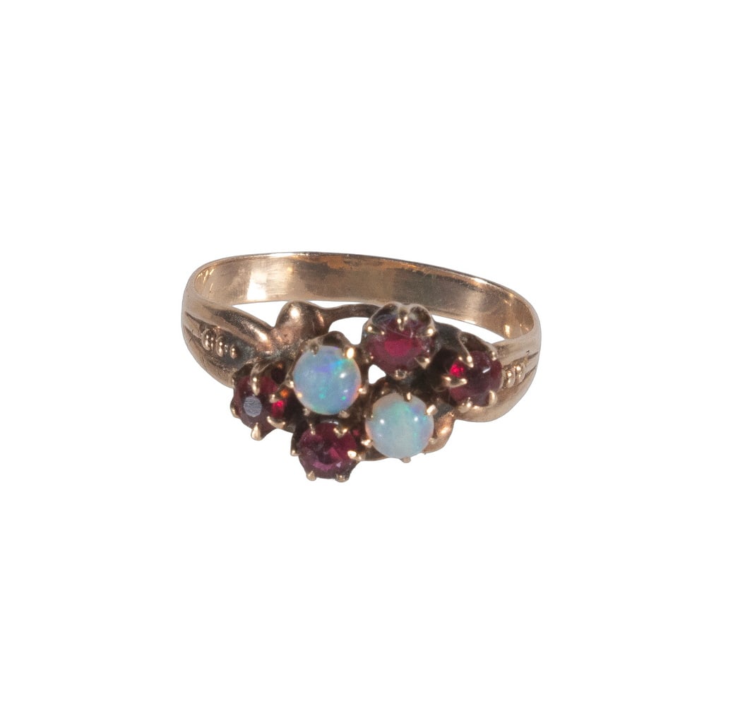 VICTORIAN 10K GOLD, OPAL, AND GARNET RING: VICTORIAN 10K GOLD, OPAL, AND GARNET RING A Victorian 10K gold ring set with (2) round opals accented by (4) garnets in an elegant arrangement. The opals display lively blue and green play-of-color, c