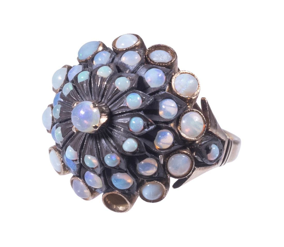 VINTAGE 14K GOLD, SILVER, AND OPAL CLUSTER RING: VINTAGE 14K GOLD, SILVER, AND OPAL CLUSTER RING The domed foliate-form mount set with (38) cabochon opals, mounted in 14K gold and silver, stamped. 6.1 dwt. tw. Missing one small opal. Some surface we