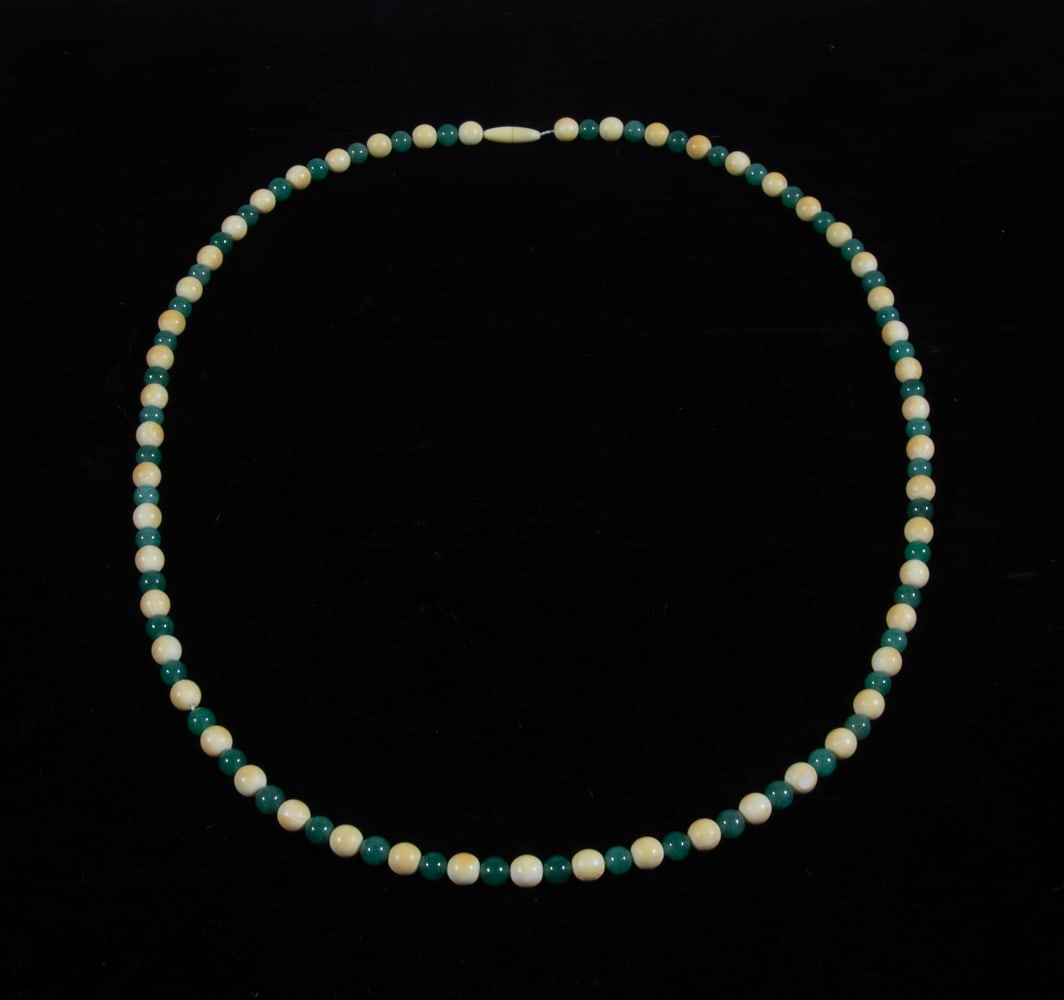 VINTAGE AVENTURINE AND BONE BEAD NECKLACE: VINTAGE AVENTURINE AND BONE BEAD NECKLACE A necklace composed of alternating 7mm green aventurine beads and 8mm cream-colored bone beads, each of spherical form with subtle natural variation and marbl