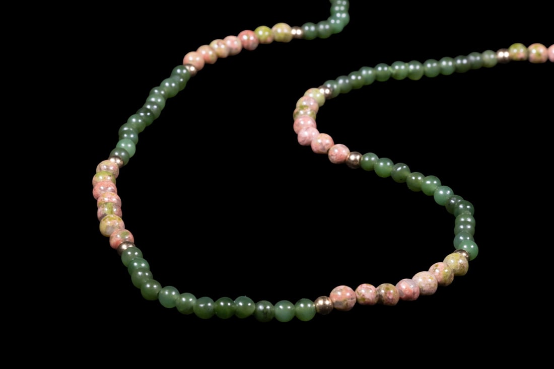 14K GOLD NEPHRITE JADE, AND UNAKITE BEAD NECKLACE: 14K GOLD NEPHRITE JADE, AND UNAKITE BEAD NECKLACE A long beaded necklace composed of polished green nephrite jade beads measuring approximately 4.5 mm, interspersed with unakite beads measuring approx