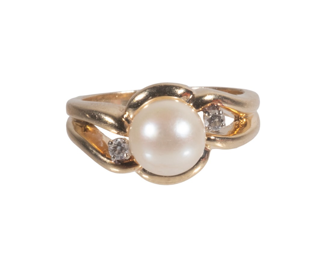 VINTAGE 14K GOLD PEARL AND DIAMOND RING: VINTAGE 14K GOLD PEARL AND DIAMOND RING A 14K gold ring set with one creamy white cultured pearl measuring approximately 8 mm, accented by two small round diamonds in a flowing modernist-style setting