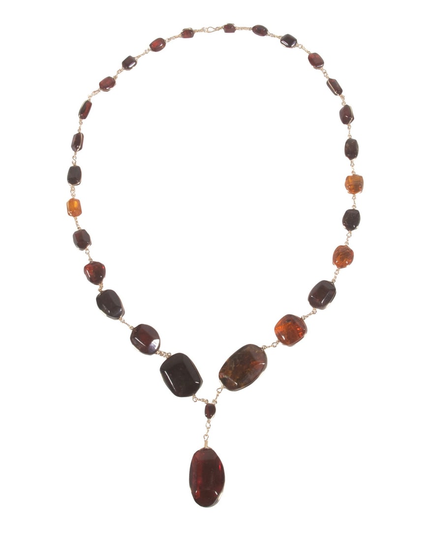 BALTIC AMBER AND GOLD-PLATED NECKLACE: BALTIC AMBER AND GOLD-PLATED NECKLACE Composed of polished amber plaques and beads in varying shades of cognac, honey, and deep cherry amber, joined by gold-tone metal links. Amber elements measure ap