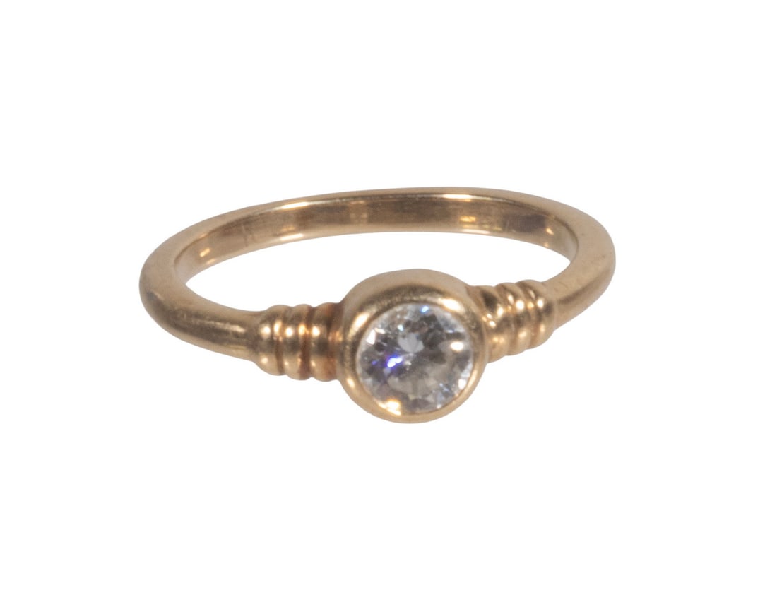 14K GOLD AND DIAMOND SOLITAIRE RING: 14K GOLD AND DIAMOND SOLITAIRE RING 14K yellow gold ring centering one round brilliant-cut diamond weighing approximately 0.36 carat, graded I color, SI2 clarity. The diamond is bezel-set within a cir
