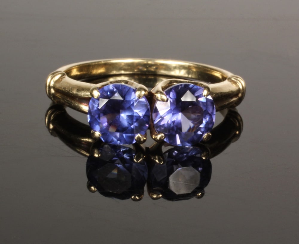 14K GOLD AND SYNTHETIC SAPPHIRE LADIES RING: 14K GOLD AND SYNTHETIC SAPPHIRE LADIES RING 14K Yellow Gold Sapphire Ring, prong set with round, faceted synthetic blue sapphires weighing approx. 1.18 ct. and 1.12 ct. each, yellow gold mounting with