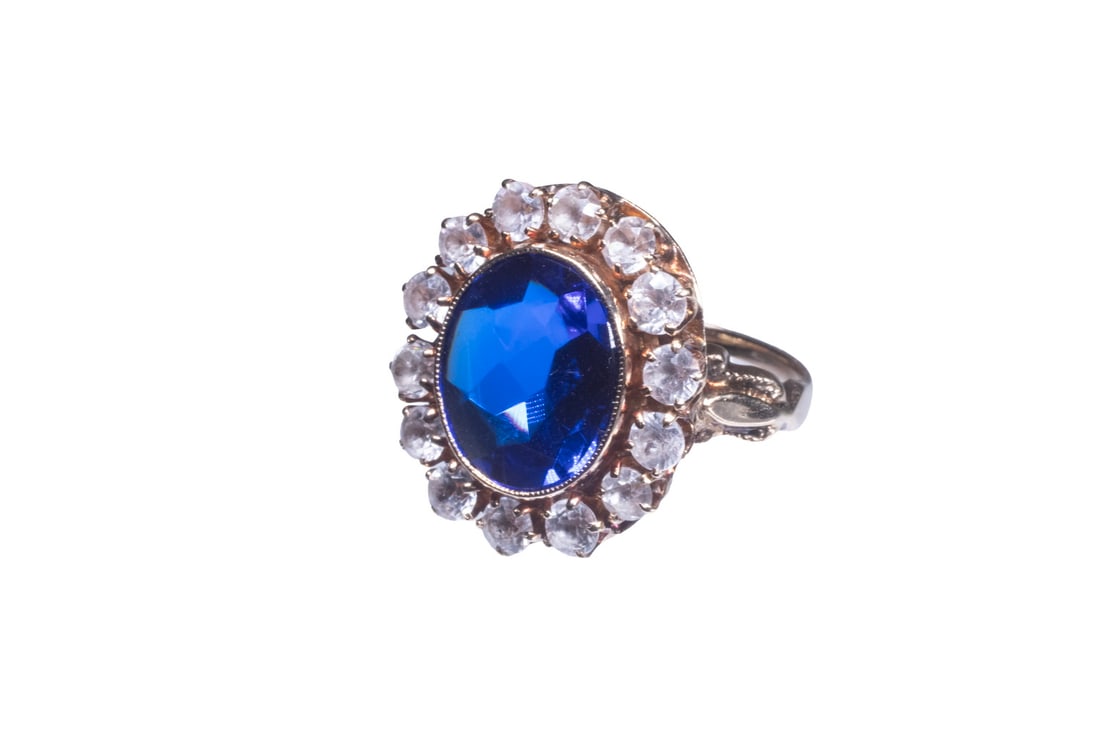 VICTORIAN 14K GOLD, BUFF-TOP BLUE SPINEL AND TOPAZ RING: VICTORIAN 14K GOLD, BUFF-TOP BLUE SPINEL AND TOPAZ RING A 14K gold ring centering an oval buff-top cut blue spinel measuring approximately 11.51 x 9.86 mm, surrounded by (14) round faceted white topaz