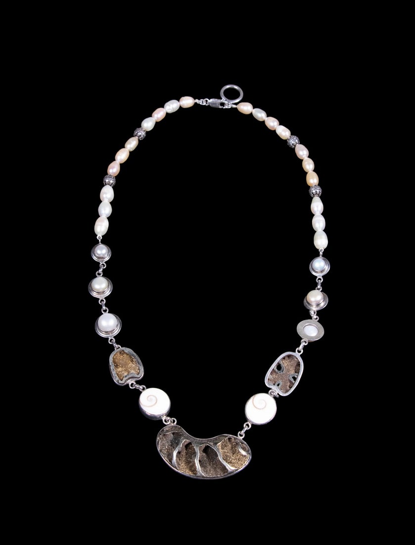 STERLING SILVER NECKLACE WITH PEARLS, SHIVA EYE SHELLS, AND DRUZY QUARTZ: STERLING SILVER NECKLACE WITH PEARLS, SHIVA EYE SHELLS, AND DRUZY QUARTZ A sterling silver necklace set with freshwater pearls, Shiva eye shells, and natural druzy quartz stones, featuring a large abs