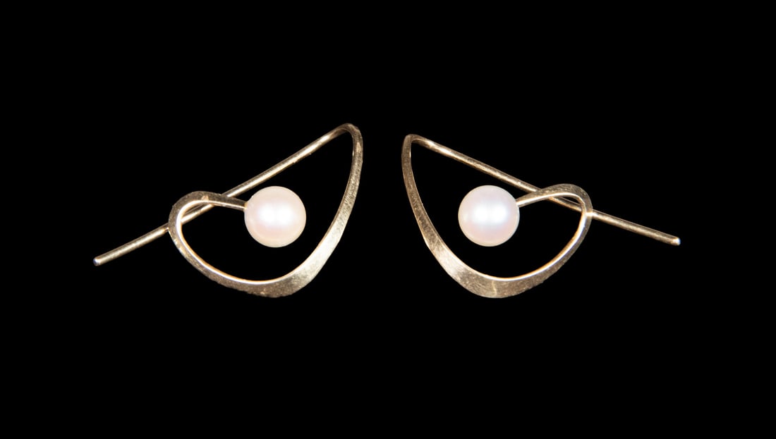 PR VINTAGE MODERNIST DESIGNED PEARL EARRINGS: PR VINTAGE MODERNIST DESIGNED PEARL EARRINGS A pair of 14K yellow gold earrings of modern, openwork design, each set with a cultured pearl measuring approximately 5.7 mm, within an angular frame, stam