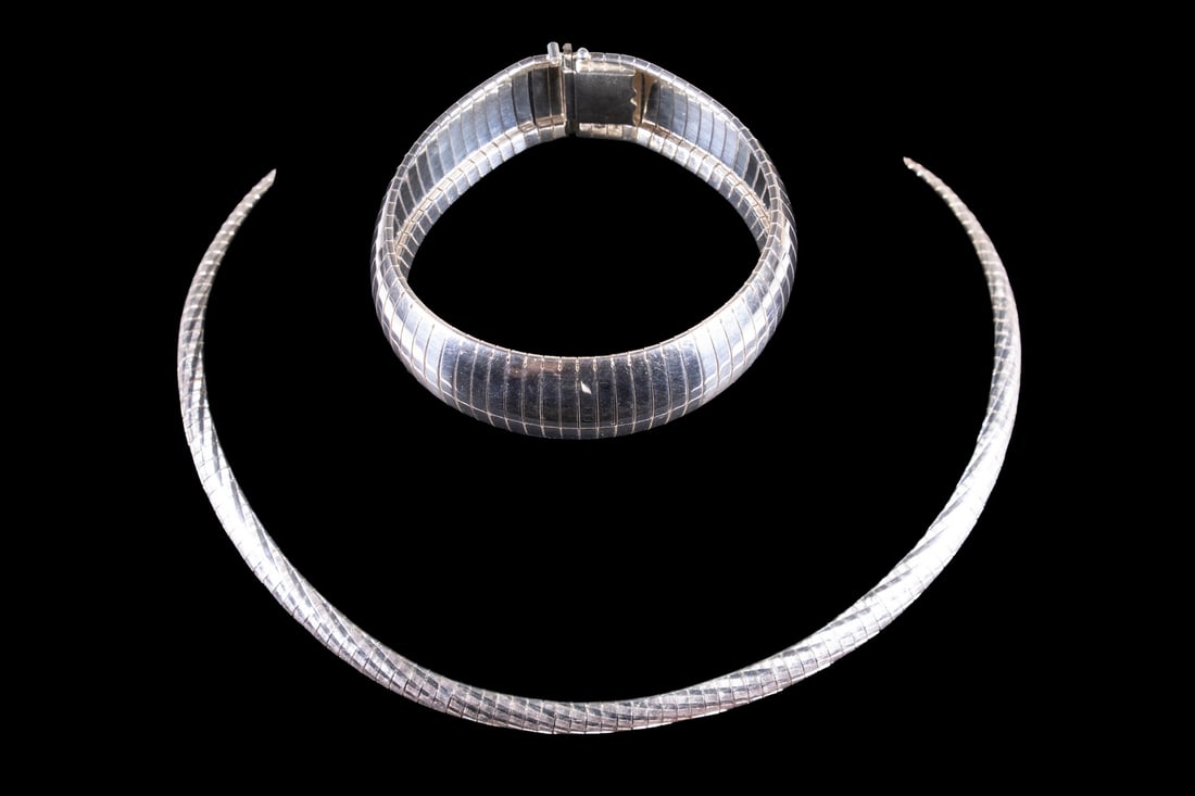 (2) ITALIAN STERLING SILVER GAS PIPE JEWELRY ITEMS: (2) ITALIAN STERLING SILVER GAS PIPE JEWELRY ITEMS A group of two Italian sterling silver jewelry items in flexible gas pipe construction, including a collar necklace and bracelet. The necklace with t
