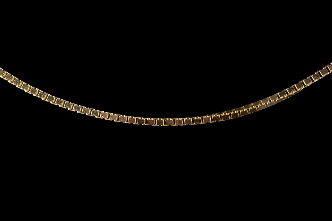 ITALIAN 14K GOLD BOX CHAIN NECKLACE: ITALIAN 14K GOLD BOX CHAIN NECKLACE An Italian 14K gold necklace formed as a fine box chain, composed of closely linked square segments creating a smooth and flexible structure. Completed with a lobst