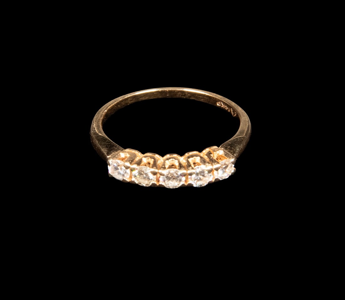 14K GOLD FIVE-DIAMOND BAND RING: 14K GOLD FIVE-DIAMOND BAND RING Designed as a band set with (5) round brilliant-cut diamonds, each measuring approximately 3.07 mm, totaling an estimated 0.50 carats. The diamonds display lively brill