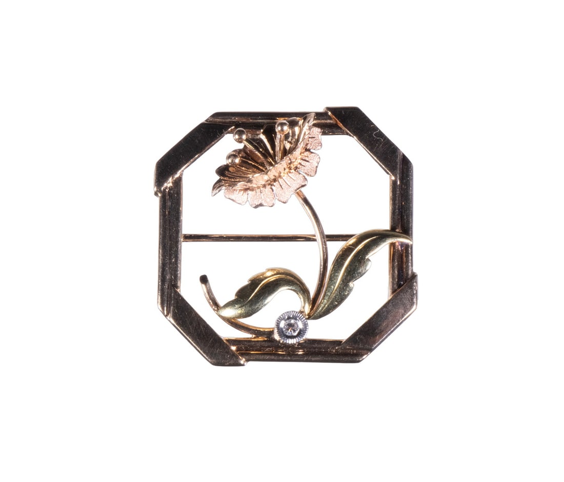 VINTAGE 10K MULTI-COLOR GOLD FLORAL BROOCH WITH DIAMOND ACCENT: VINTAGE 10K MULTI-COLOR GOLD FLORAL BROOCH WITH DIAMOND ACCENT An octagonal 10K gold brooch featuring a delicately crafted flower with textured petals in yellow and rose gold tones. The design is acce