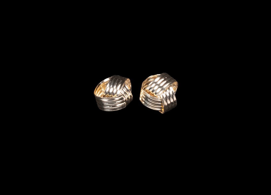 PR 14K GOLD TEXTURED STUD EARRINGS: PR 14K GOLD TEXTURED STUD EARRINGS A pair of 14K yellow gold stud earrings featuring a sculptural woven design with alternating polished and textured surfaces. Fitted with post backs, all stamped. 0.7