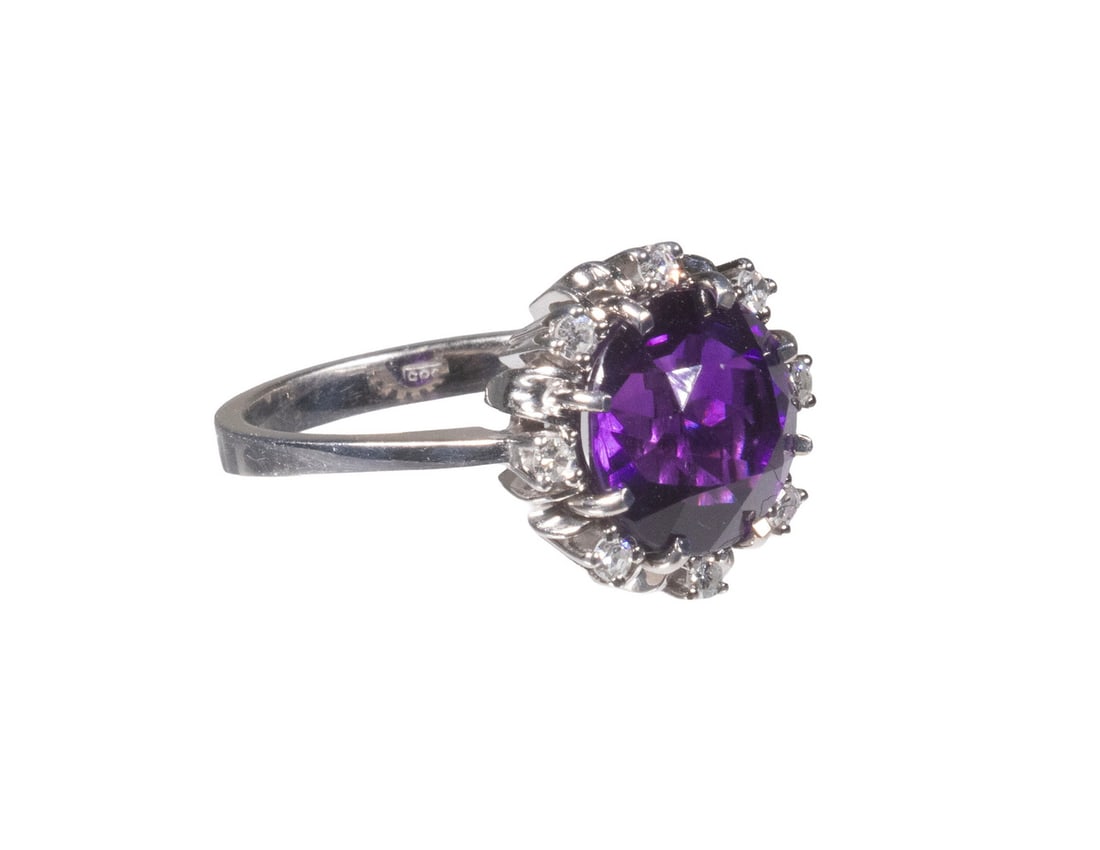 14K GOLD, AMETHYST, AND DIAMOND RING: 14K GOLD, AMETHYST, AND DIAMOND RING Centering a round faceted vivid royal purple amethyst measuring approximately 9.92 mm in diameter, accented by (8) round brilliant-cut diamonds. Mounted in 14K whi