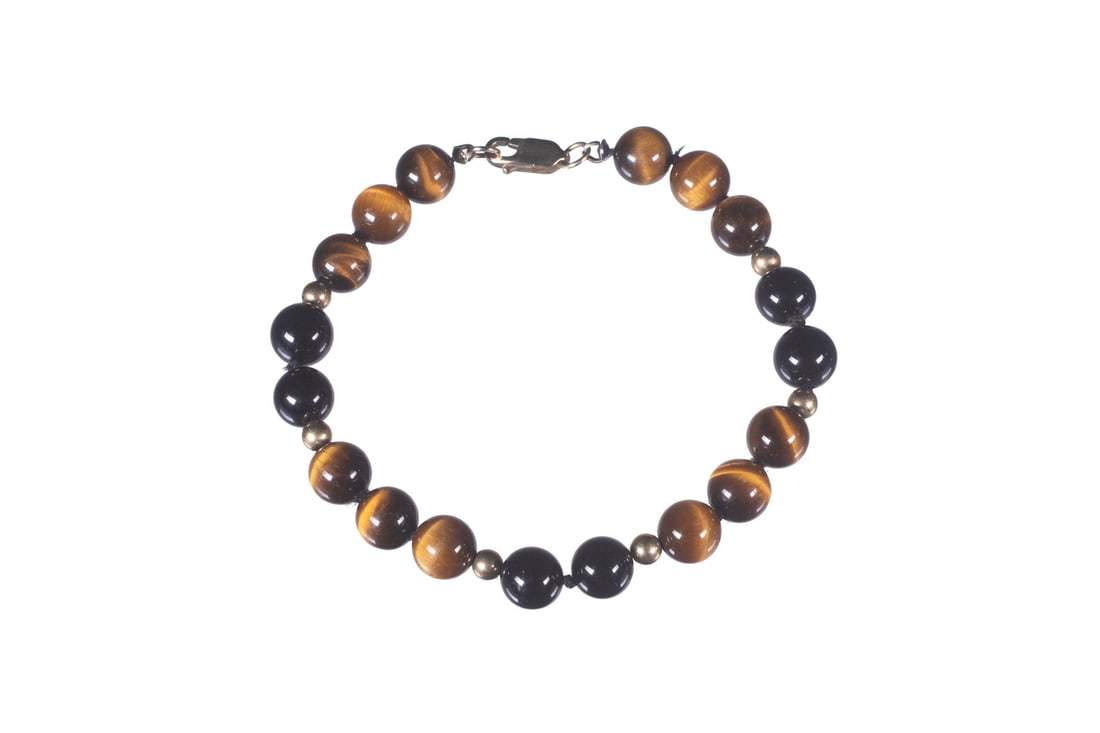 14K GOLD AND TIGER'S EYE BEAD BRACELET: 14K GOLD AND TIGER'S EYE BEAD BRACELET A bracelet composed of (18) polished tiger's eye beads measuring approximately 7.91 to 8.37 mm, interspersed with (6) 14K gold spacer beads measuring approximate