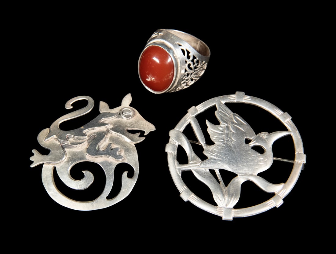 (3) STERLING SILVER JEWELRY ITEMS: (3) STERLING SILVER JEWELRY ITEMS Including two sterling silver brooches, one depicting a hummingbird within a circular frame marked ?BRKS STERLING,? the other a Mexican stylized figure brooch signed 
