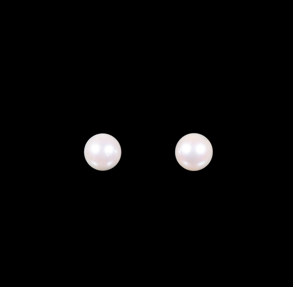 PR 14K GOLD PEARL STUDS EARRINGS: PR 14K GOLD PEARL STUDS EARRINGS Each earring set with a 7mm round white cultured pearl mounted on a simple 14K white gold post setting, secured with butterfly backs. Diameter: 7mm