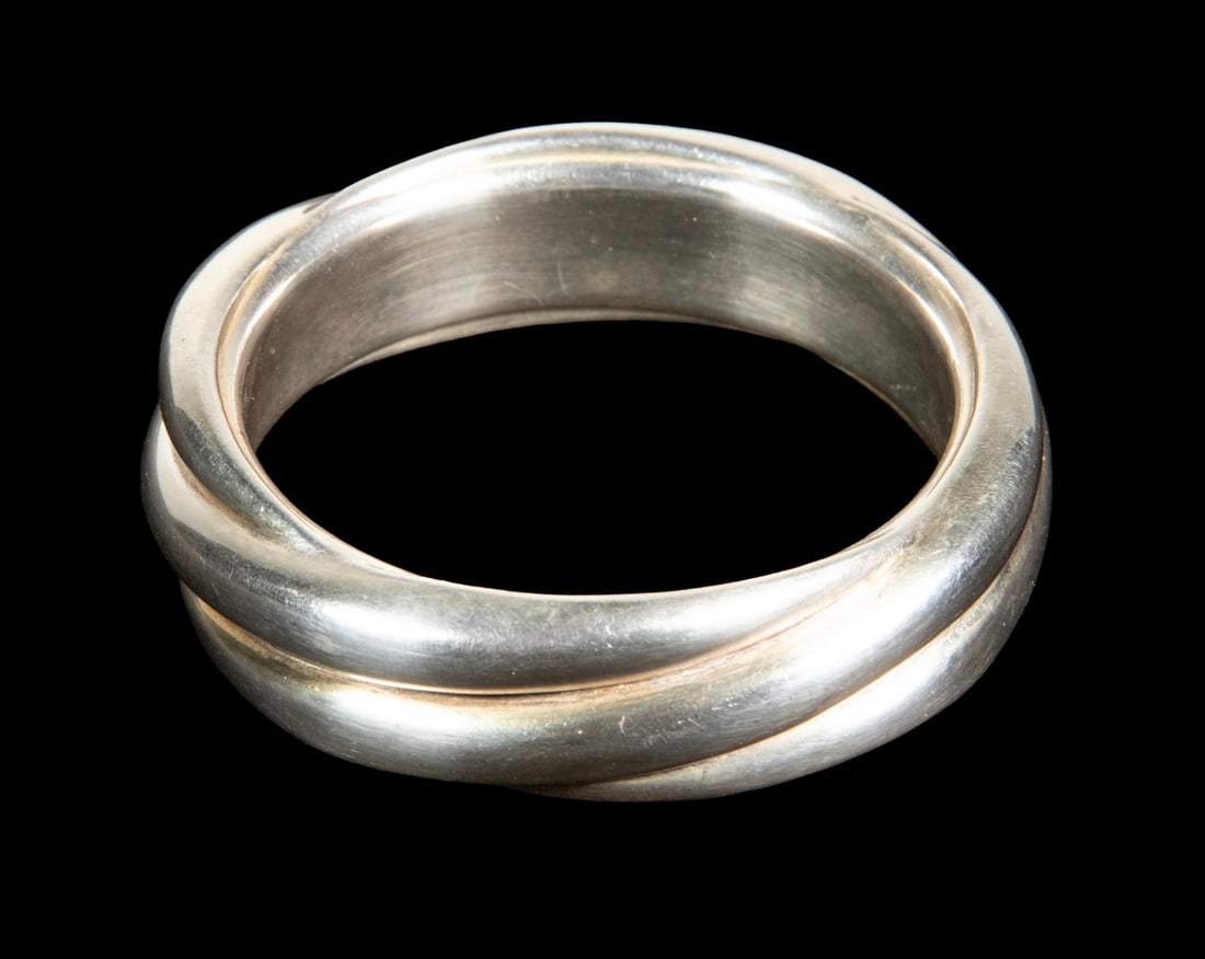 STERLING SILVER TRIPLE TWIST BANGLE BRACELET: STERLING SILVER TRIPLE TWIST BANGLE BRACELET Three-Strand Hollow Tube Bracelet, likely Mexican, the interior stamped "925." 1.96 ozt. Width: 1 in. (2.5 cm.), Interior Diameter: 2 3/4 in. (7 cm.)
