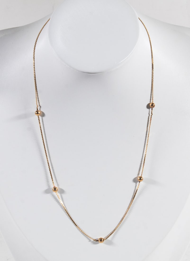 14K GOLD STATION NECKLACE WITH GOLD BEADS: 14K GOLD STATION NECKLACE WITH GOLD BEADS A delicate 14K gold station necklace featuring (5) polished gold bead accents measuring approximately 4 mm each, spaced along a fine link chain. Simple and