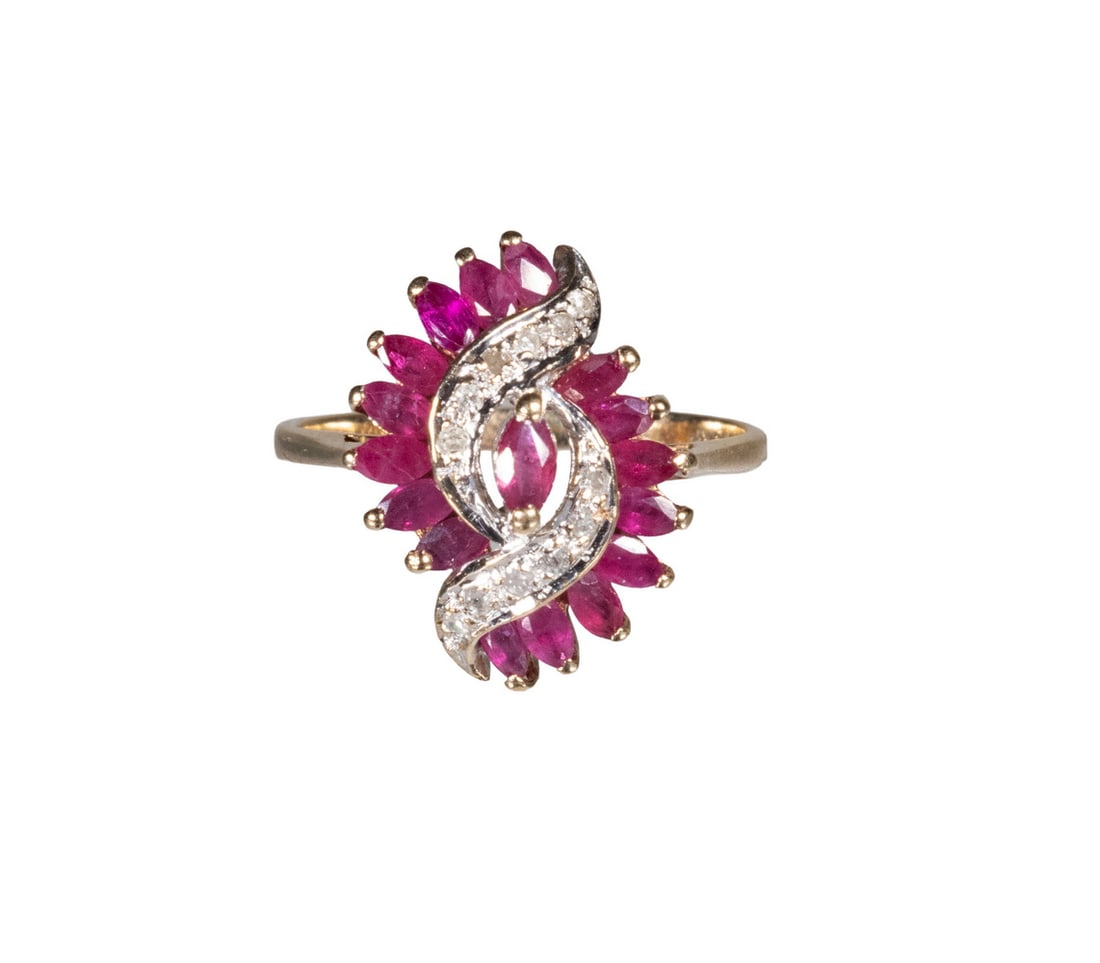 10K GOLD RUBY AND DIAMOND RING: 10K GOLD RUBY AND DIAMOND RING A 10K yellow gold ring set with (17) marquise-cut rubies arranged in a radiating cluster, accented by a scrolling motif set with (12) diamond melee. The design forms a b