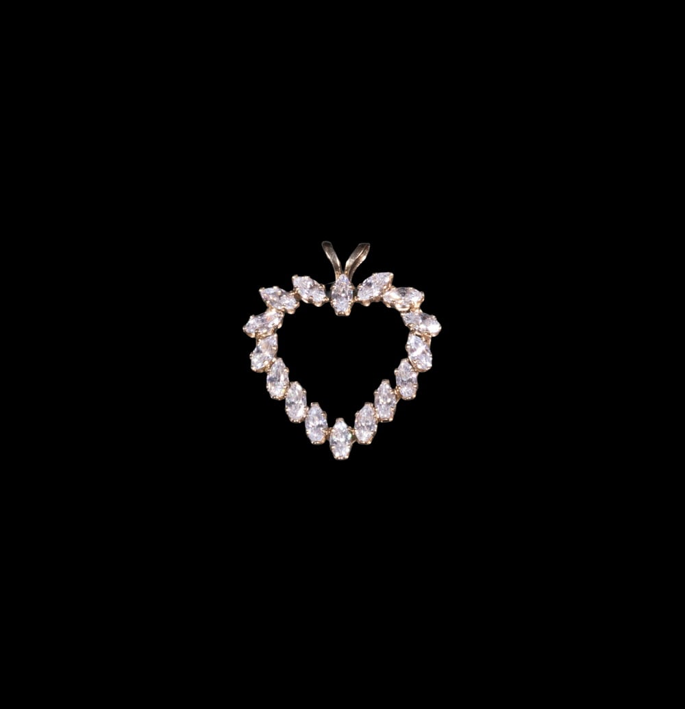 10K GOLD AND CUBIC ZIRCONIA HEART PENDANT: 10K GOLD AND CUBIC ZIRCONIA HEART PENDANT A 10K yellow gold open heart pendant set with marquise-cut cubic zirconia, creating a delicate and sparkling outline. 0.7 dwt. total weight. 0 7/8 x 0 3/4