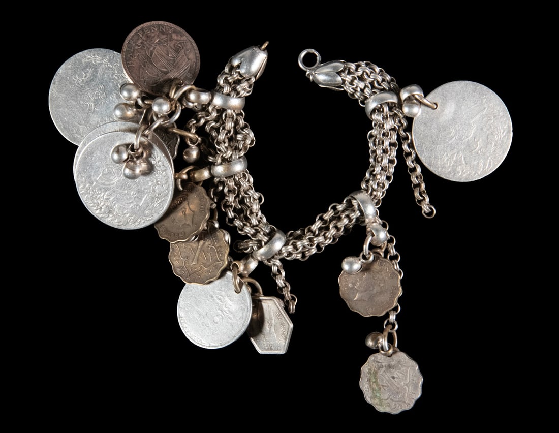 MIDDLE EASTERN SILVER BRACELET WITH ENGLISH & OTTOMAN COINS: MIDDLE EASTERN SILVER BRACELET WITH ENGLISH & OTTOMAN COINS Vintage Triple Link Bracelet, with (7) suspended English and British India (George VI) coins and (6) Ottoman coins. Length: 6 1/2 in. (16.5