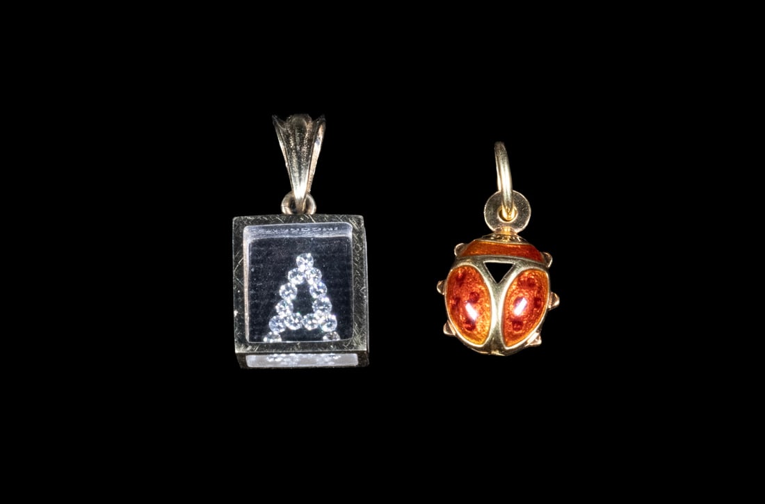 (2) PENDANTS, 14K DIAMOND "A" INITIAL AND 18K ENAMEL SCARAB: (2) PENDANTS, 14K DIAMOND "A" INITIAL AND 18K ENAMEL SCARAB A group of two gold pendants. One in 14K gold, of square form, featuring (13) small round diamonds arranged to form the letter “A,” 