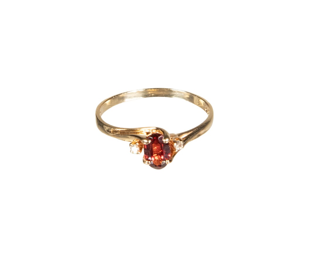 VINTAGE 10K GOLD, GARNET, AND DIAMOND RING: VINTAGE 10K GOLD, GARNET, AND DIAMOND RING A 10K yellow gold ring centering an oval-cut garnet measuring approximately 6.08 x 4.13 mm, accented by small round diamond melee to each shoulder. Designed