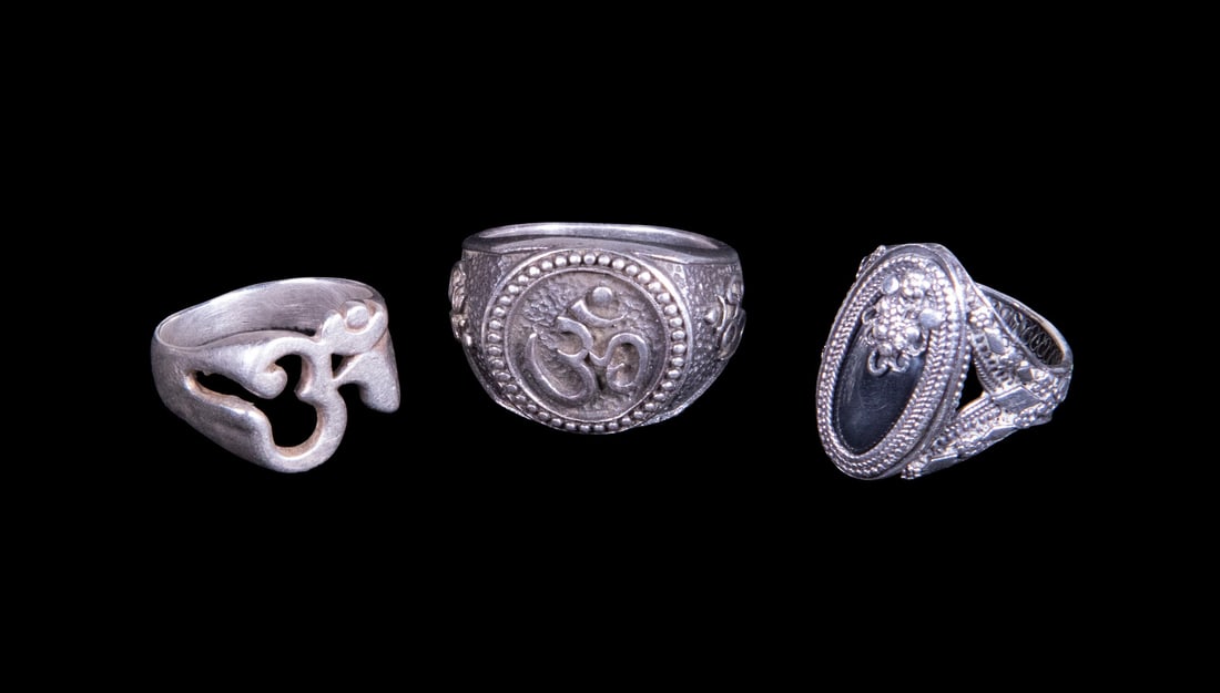 (3) STERLING SILVER RINGS, INCLUDING HEMATITE STONE: (3) STERLING SILVER RINGS, INCLUDING HEMATITE STONE A group of three sterling silver rings, including a large oval cabochon hematite ring in an ornate setting, a ring featuring an Arabic symbol in