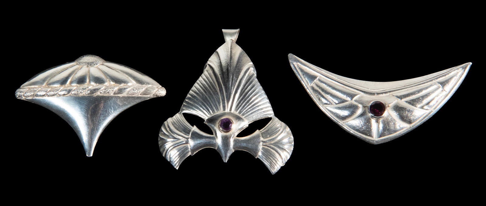 (3) STERLING SILVER BROOCHES, TWO ARTISAN SIGNED: (3) STERLING SILVER BROOCHES, TWO ARTISAN SIGNED Group of (3) Brooches, two set with faceted amethysts, two marked 925 and inscribed with an entwined SH mark, one an unmarked pendant brooch. 0.65 ozt