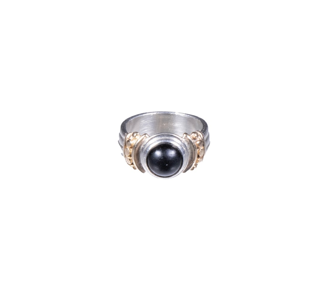 14K GOLD AND STERLING SILVER RING WITH ONYX: 14K GOLD AND STERLING SILVER RING WITH ONYX A modern ring crafted in sterling silver with applied 14k yellow gold bead and band accents, centering a polished black onyx cabochon. Ring size: 3 1/2