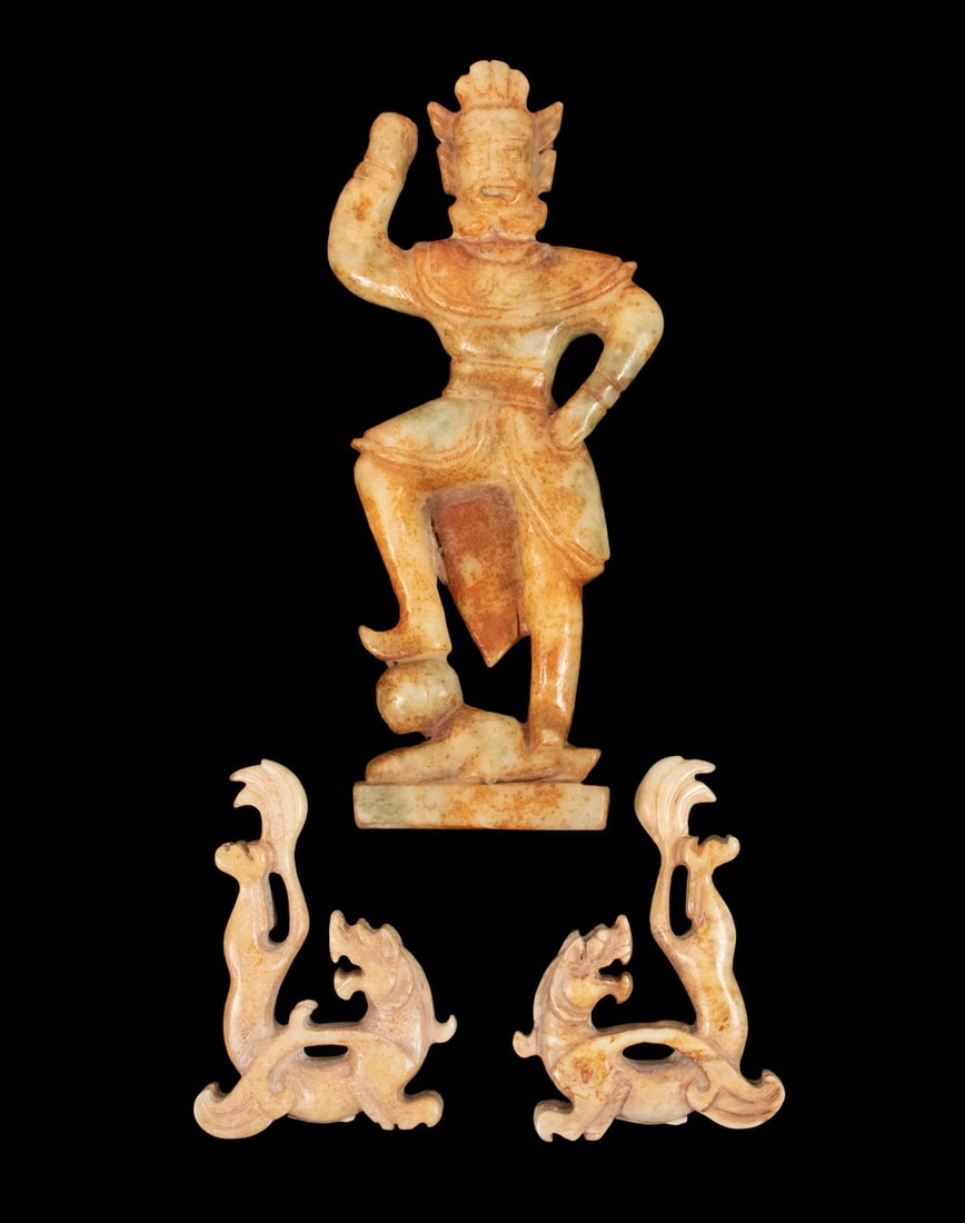 (3) CHINESE JADE CARVINGS: (3) CHINESE JADE CARVINGS A group of three Chinese archaistic style carvings comprising a standing guardian figure depicted with one arm raised and wearing stylized armor, together with a pair of open