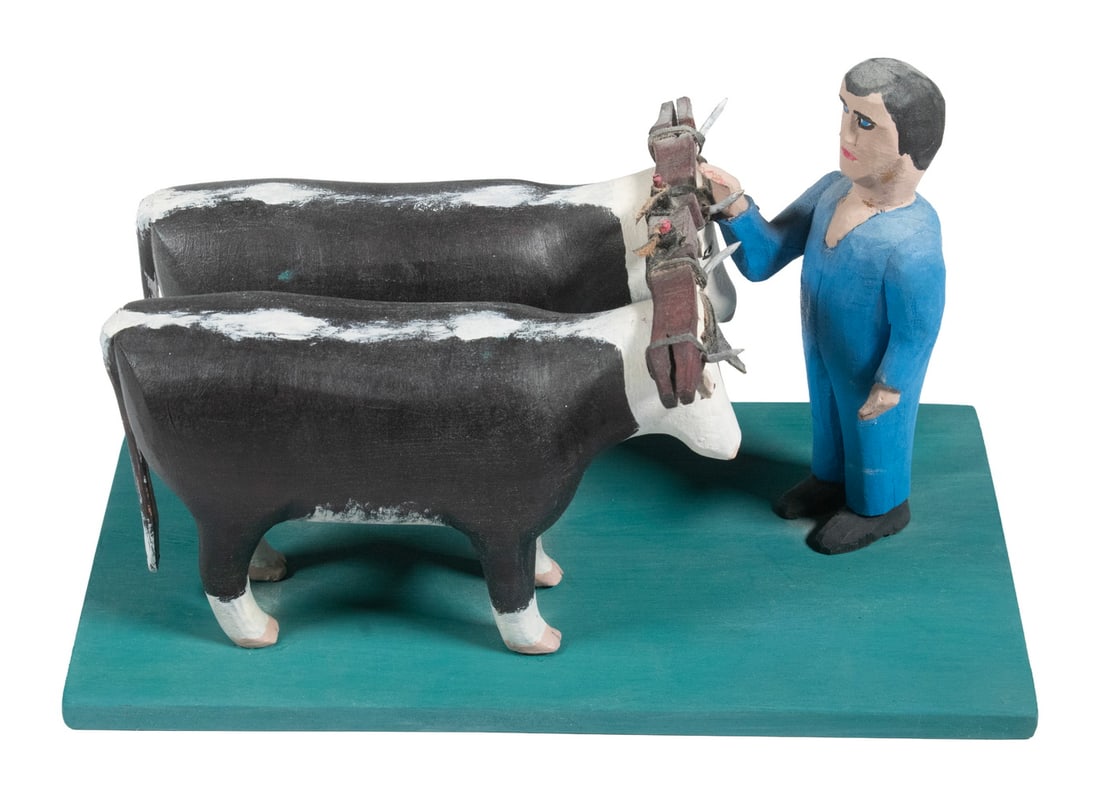 CANADIAN FOLK ART CARVING OF TEAMSTER: CANADIAN FOLK ART CARVING OF TEAMSTER Yoked Team of Oxen with Standing Man, carved and painted wood, late 20th century. Stamped on underside by Donald Boudreau of Weymouth, Nova Scotia. OS: 5 1/2 x 9