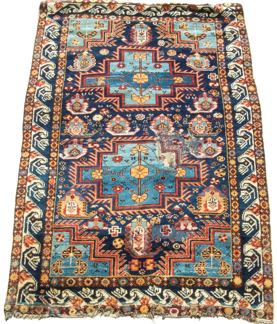 SMALL CAUCASIAN RUG(5'7" x 3'6'): SMALL CAUCASIAN RUG(5'7" x 3'6') An offering of a small Caucasian floor covering. Features a dark blue field with two central medallions and repeating geometric designs and palmettes with a blue and