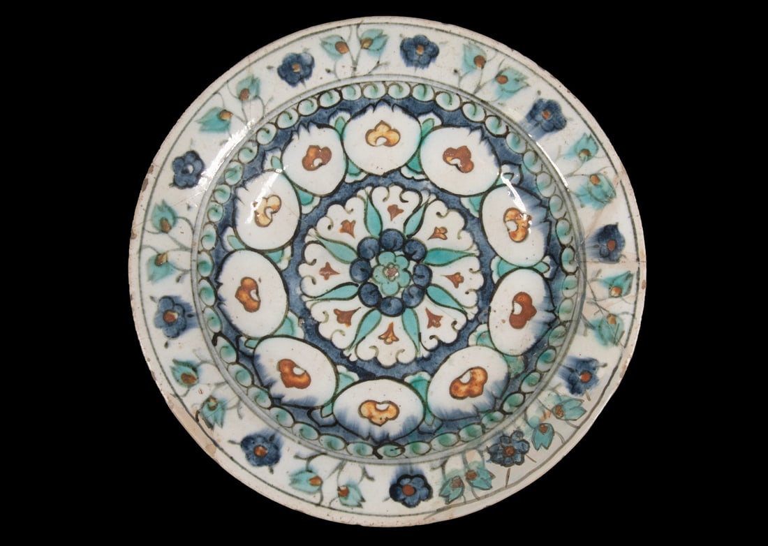 TURKISH IZNIK POTTERY DISH: TURKISH IZNIK POTTERY DISH Late 16th - Early 17th c. Glazed Ceramic Low Bowl, with turquoise, red, cobalt blue, and black painted floral decoration. Repaired breaks. OS: 2 1/2 x 11 3/4 x 11 3/4 in.