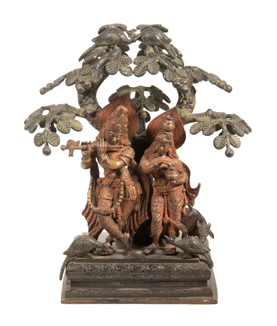 POLYCHROME ENAMELED INDIAN BRONZE OF SHIVA AND PARVATI: POLYCHROME ENAMELED INDIAN BRONZE OF SHIVA AND PARVATI Hindu Altar Figures under tree flanked by birds and a cow, also with pair of birds at top of tree, both with flame halo, he is playing flute,