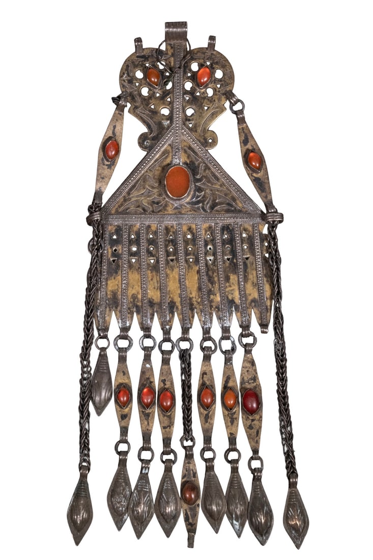 TURKOMAN SILVER AND GLASS DANGLE ORNAMENT: TURKOMAN SILVER AND GLASS DANGLE ORNAMENT A Central Asian Turkoman silver ornament of triangular form, set with multiple cabochon carnelian-red glass. The lower section with articulated pendant