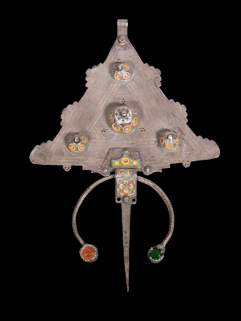 MOROCCAN SILVER AND ENAMEL TRIANGULAR PENDANT: MOROCCAN SILVER AND ENAMEL TRIANGULAR PENDANT A large triangular pendant of sheet silver construction, decorated with applied domed bosses and polychrome enamel in green and yellow. The surface with
